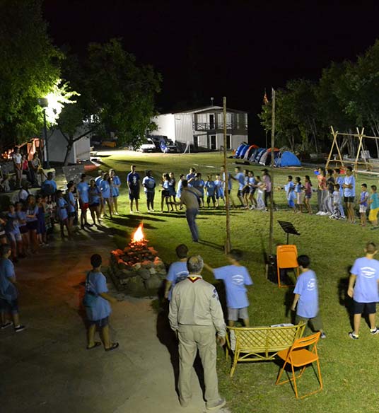 Rangers dancing by the fire at night